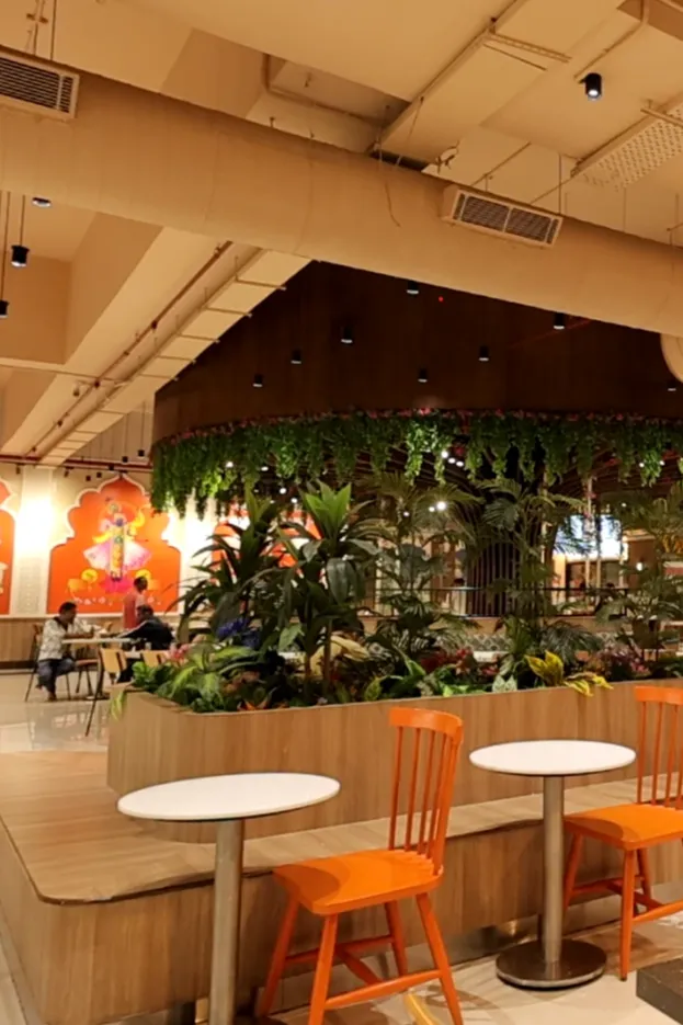 Decorative greenery and indoor planters adding freshness to the Annakoot Restaurant interior design.