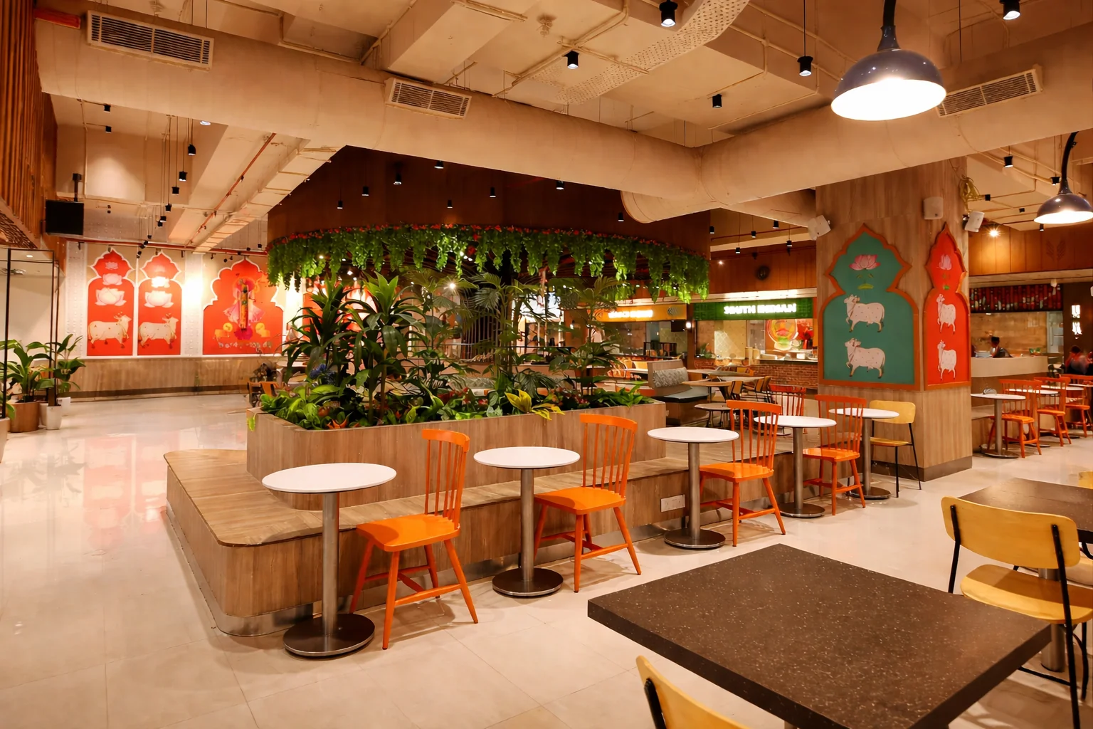 Spacious vegetarian dining interior with greenery and traditional decor at Annakoot Restaurant